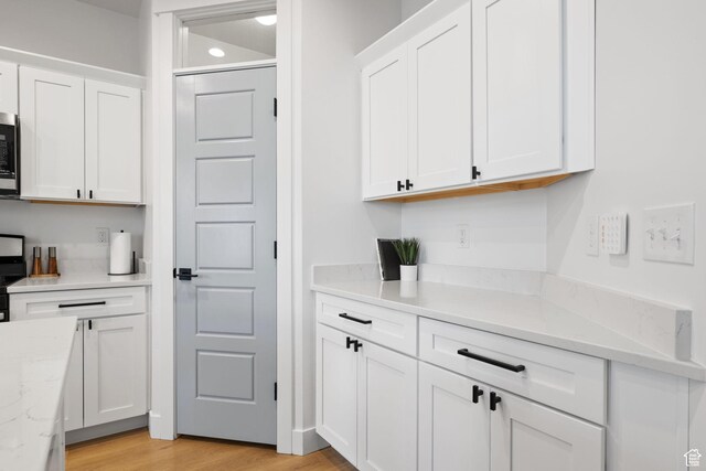 13077 S Keegan Dr, Herriman, UT 84096 - bar with electric range oven, stainless steel microwave, and light wood-style floors