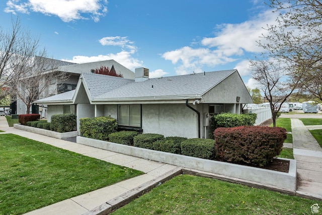 223 E Hill Ave Unit 6, Millcreek, UT 84107 - view of side of property featuring a yard, stucco siding, a chimney, and a shingled roof