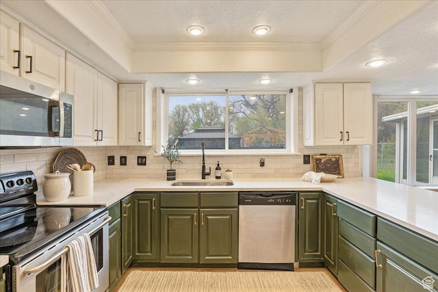 2748 W 220 N, Provo, UT 84601 - kitchen featuring a sink, green cabinets, stainless steel appliances, and backsplash