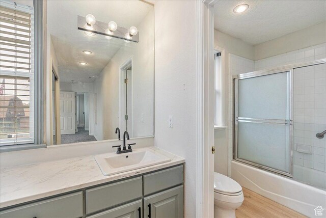 2748 W 220 N, Provo, UT 84601 - full bathroom with vanity, bath / shower combo with glass door, a wealth of natural light, and toilet