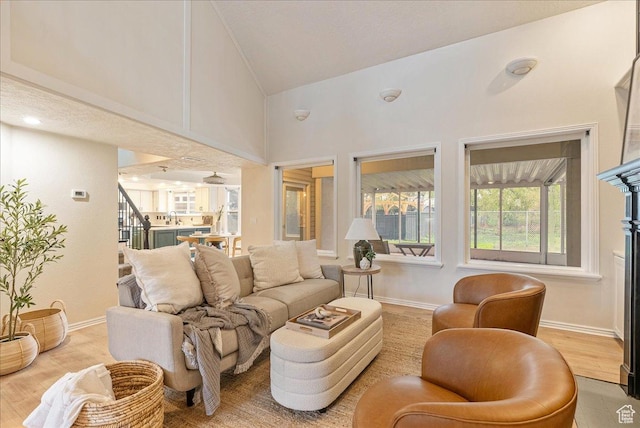 2748 W 220 N, Provo, UT 84601 - living area with stairs, high vaulted ceiling, baseboards, and light wood-style floors