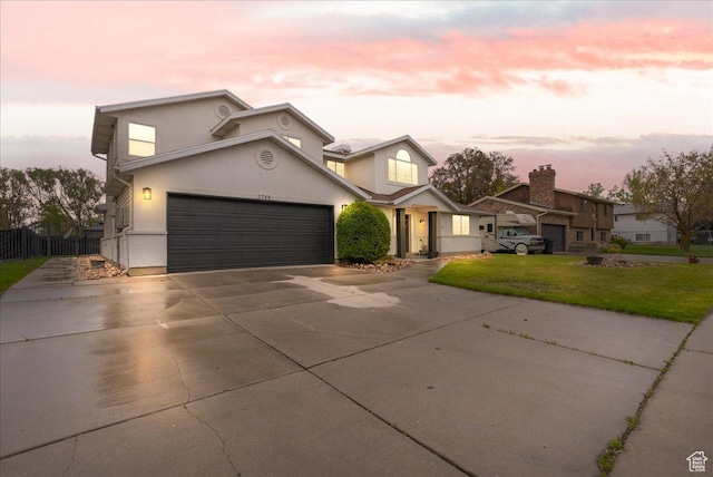2748 W 220 N, Provo, UT 84601 - traditional-style home featuring fence, an attached garage, concrete driveway, and a front lawn