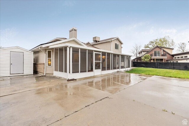2748 W 220 N, Provo, UT 84601 - rear view of house with a storage shed, a sunroom, fence, an outdoor structure, and a yard