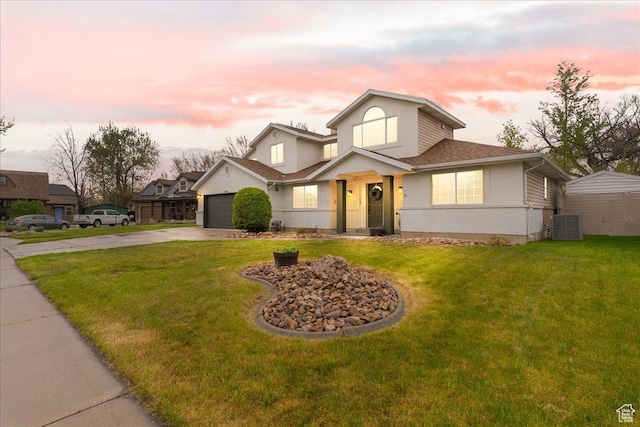 2748 W 220 N, Provo, UT 84601 - traditional home with a garage, stucco siding, central AC unit, a lawn, and driveway