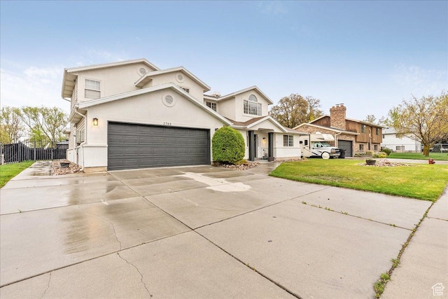 2748 W 220 N, Provo, UT 84601 - traditional home featuring fence, an attached garage, stucco siding, a front yard, and driveway