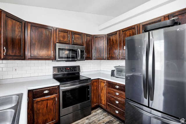 176 N Wapiti Loop E, Hyrum, UT 84319 - kitchen with tasteful backsplash, dark brown cabinets, light countertops, a sink, and stainless steel appliances