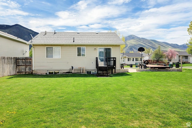 176 N Wapiti Loop E, Hyrum, UT 84319 - rear view of property featuring fence, a mountain view, and a lawn