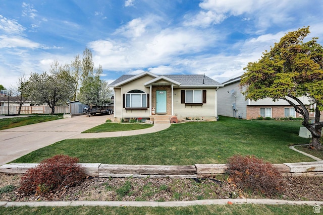 176 N Wapiti Loop E, Hyrum, UT 84319 - view of front of property featuring entry steps, fence, driveway, and a front yard