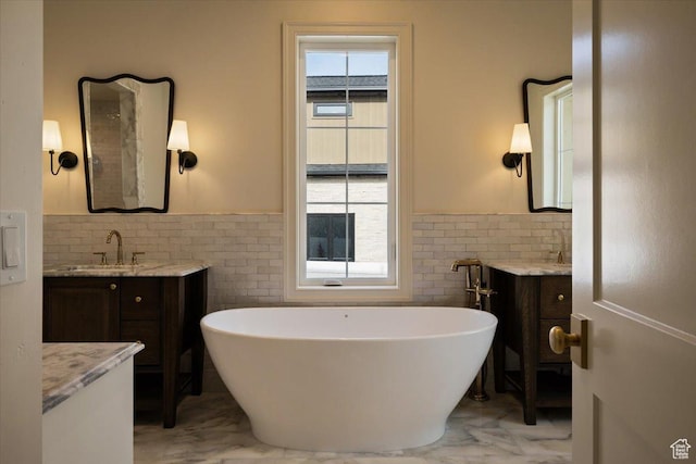473 W 350 S Unit 31, Mapleton, UT 84664 - full bathroom featuring marble finish floor, a freestanding tub, wainscoting, tile walls, and a sink