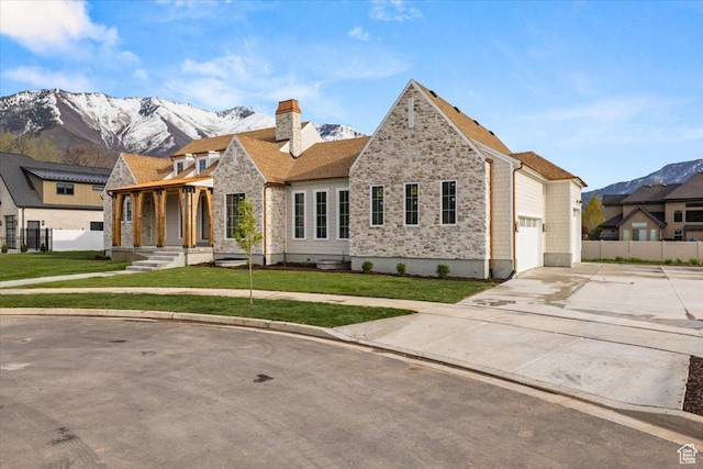 473 W 350 S Unit 31, Mapleton, UT 84664 - view of front of house featuring driveway, a chimney, a mountain view, a front lawn, and stone siding