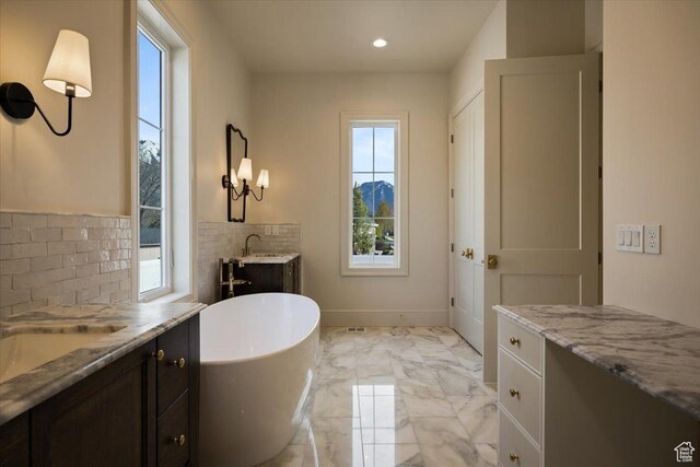 473 W 350 S Unit 31, Mapleton, UT 84664 - full bathroom featuring decorative backsplash, a freestanding bath, vanity, marble finish floor, and recessed lighting