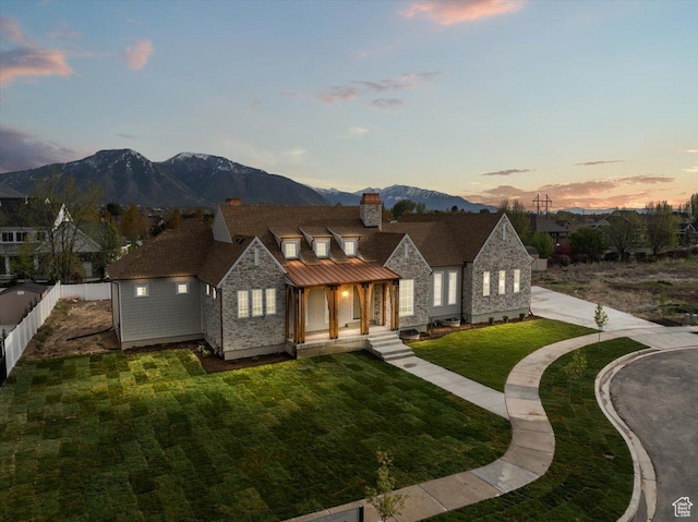 473 W 350 S Unit 31, Mapleton, UT 84664 - view of front of house featuring a front lawn, fence, stone siding, a chimney, and a mountain view
