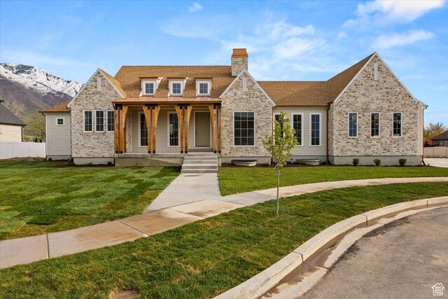 473 W 350 S Unit 31, Mapleton, UT 84664 - view of front of property featuring fence, stone siding, a front yard, a chimney, and covered porch