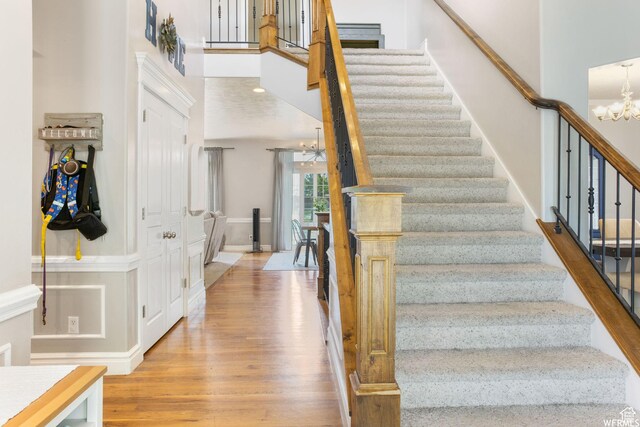 11282 S Alpine Creek Way S, Jordan, UT 84095 - stairway featuring baseboards, wood finished floors, and a chandelier