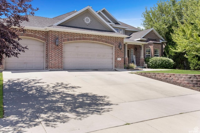 11282 S Alpine Creek Way S, Jordan, UT 84095 - view of front of property with brick siding, a garage, a shingled roof, and concrete driveway