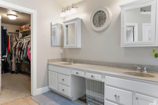 11282 S Alpine Creek Way S, Jordan, UT 84095 - bathroom featuring a sink, a walk in closet, tile patterned flooring, and double vanity