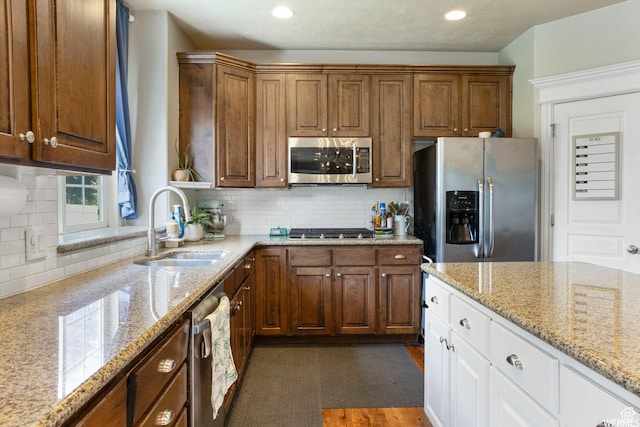 11282 S Alpine Creek Way S, Jordan, UT 84095 - kitchen with white cabinets, stainless steel appliances, decorative backsplash, and a sink