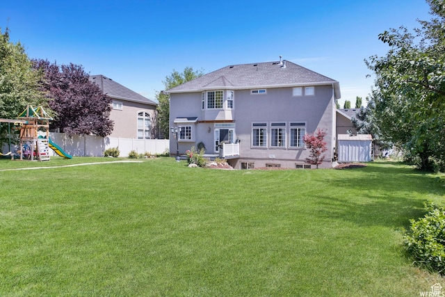 11282 S Alpine Creek Way S, Jordan, UT 84095 - rear view of house featuring fence, a yard, stucco siding, and a playground