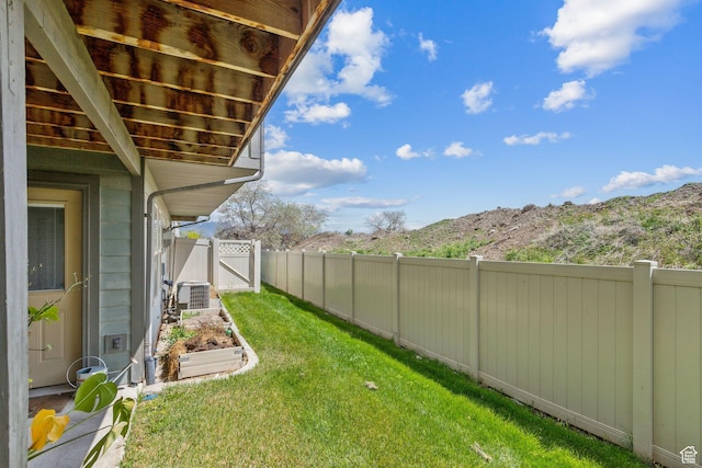 103 E River View Dr, Saratoga Springs, UT 84045 - view of yard featuring a garden, central AC unit, a gate, a mountain view, and a fenced backyard