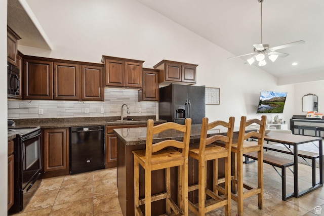 103 E River View Dr, Saratoga Springs, UT 84045 - kitchen with a sink, a center island, a ceiling fan, decorative backsplash, and black appliances
