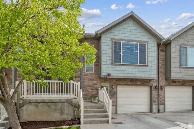 103 E River View Dr, Saratoga Springs, UT 84045 - view of front of house featuring a garage, driveway, and stone siding