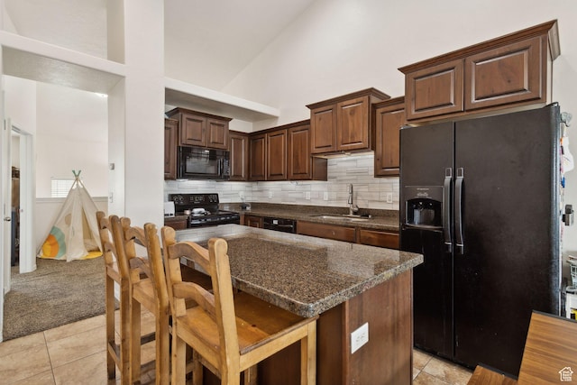 103 E River View Dr, Saratoga Springs, UT 84045 - kitchen with a sink, high vaulted ceiling, decorative backsplash, light tile patterned floors, and black appliances