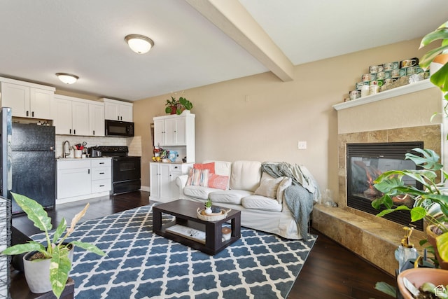 103 E River View Dr, Saratoga Springs, UT 84045 - living area with a glass covered fireplace, dark wood-style floors, and beamed ceiling