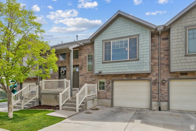 103 E River View Dr, Saratoga Springs, UT 84045 - view of property with a garage, driveway, and stone siding
