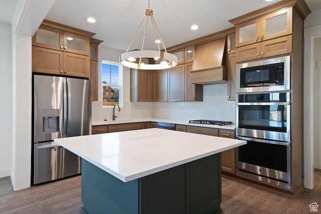 11439 S Watercourse Rd Unit 182, South Jordan, UT 84009 - kitchen with appliances with stainless steel finishes, premium range hood, dark wood-style floors, a kitchen island, and recessed lighting