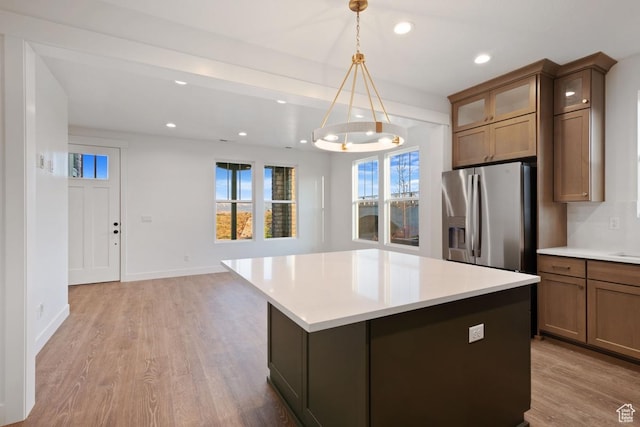 11439 S Watercourse Rd Unit 182, South Jordan, UT 84009 - kitchen featuring stainless steel refrigerator with ice dispenser, healthy amount of natural light, recessed lighting, light countertops, and light wood-style flooring