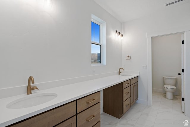 11439 S Watercourse Rd Unit 182, South Jordan, UT 84009 - full bathroom with vanity, marble look tile flooring, toilet, and baseboards