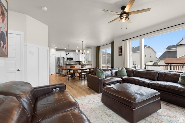 838 N Marble Rd, Tooele, UT 84074 - living room with recessed lighting, light wood finished floors, and ceiling fan with notable chandelier