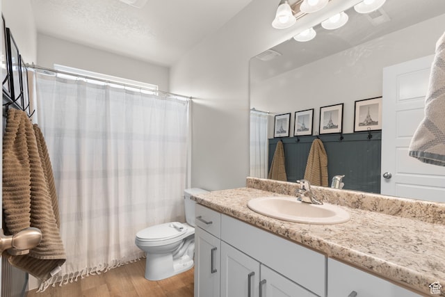 838 N Marble Rd, Tooele, UT 84074 - full bathroom featuring vanity, curtained shower, toilet, and wood finished floors