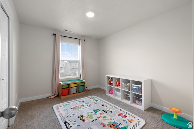 838 N Marble Rd, Tooele, UT 84074 - recreation room with carpet floors, baseboards, and visible vents