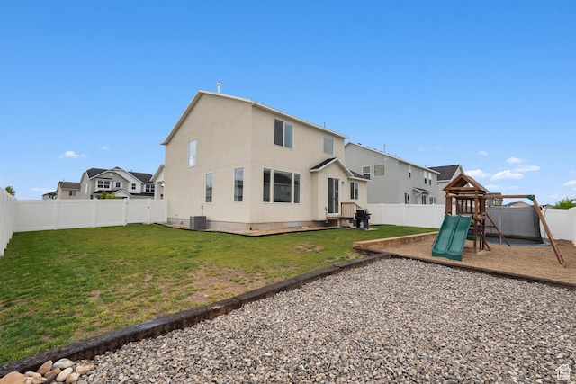 838 N Marble Rd, Tooele, UT 84074 - rear view of house with a yard, cooling unit, a fenced backyard, and a playground