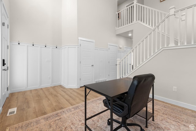 838 N Marble Rd, Tooele, UT 84074 - home office featuring visible vents, wainscoting, a decorative wall, wood finished floors, and a high ceiling