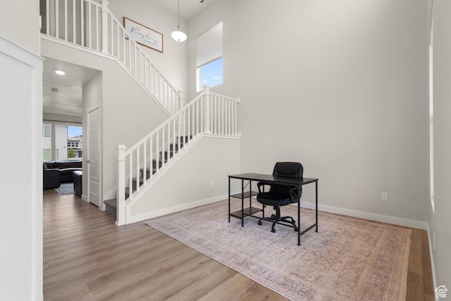 838 N Marble Rd, Tooele, UT 84074 - office area featuring baseboards, a high ceiling, and wood finished floors