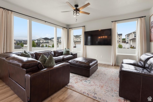 838 N Marble Rd, Tooele, UT 84074 - living room featuring ceiling fan, baseboards, and light wood-style floors