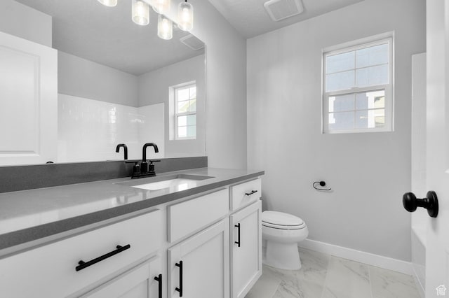 6628 W Spring Snow Ln, Herriman, UT 84096 - full bathroom featuring vanity, toilet, marble look tiles, and baseboards