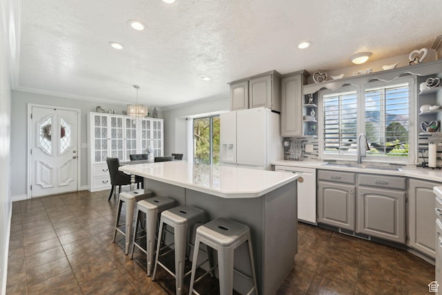 867 E 2850 N, North Ogden, UT 84414 - kitchen with open shelves, a sink, white appliances, gray cabinets, and a center island