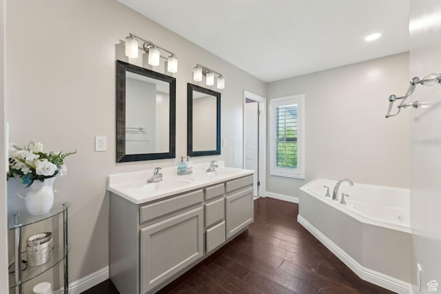 867 E 2850 N, North Ogden, UT 84414 - bathroom with a sink, baseboards, a bath, and wood finished floors