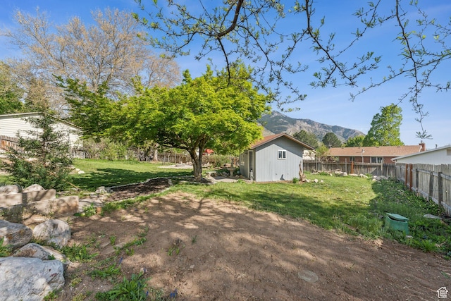 867 E 2850 N, North Ogden, UT 84414 - view of yard with a fenced backyard, a mountain view, and an outbuilding
