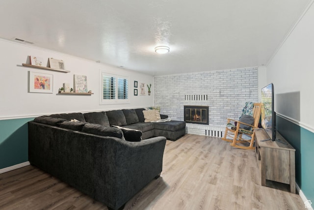 867 E 2850 N, North Ogden, UT 84414 - living area featuring visible vents, crown molding, a fireplace, wood finished floors, and baseboards