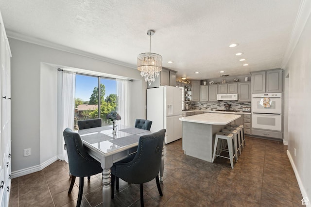 867 E 2850 N, North Ogden, UT 84414 - dining room featuring crown molding, a textured ceiling, baseboards, and a chandelier