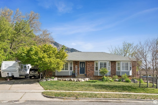 867 E 2850 N, North Ogden, UT 84414 - ranch-style house featuring brick siding, a mountain view, a front lawn, concrete driveway, and a shingled roof