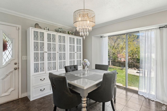 867 E 2850 N, North Ogden, UT 84414 - dining space with dark tile patterned floors, an inviting chandelier, and ornamental molding