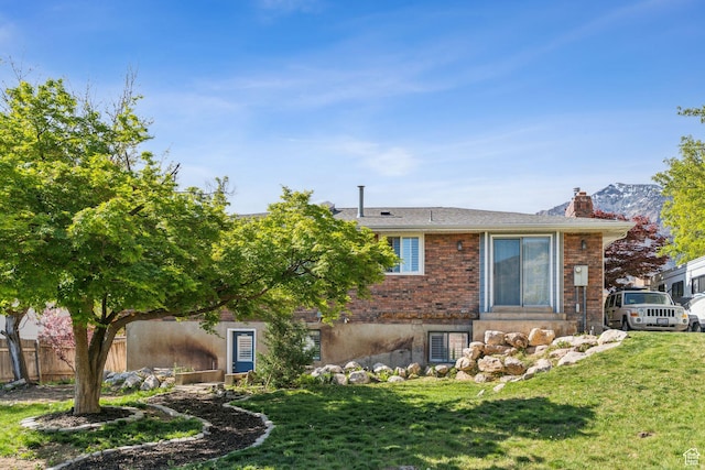 867 E 2850 N, North Ogden, UT 84414 - back of house with a yard, brick siding, fence, and a chimney