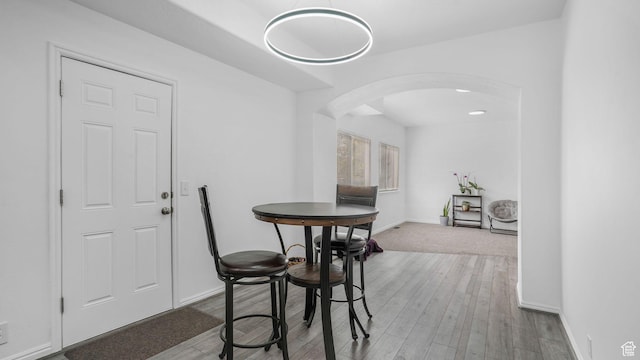 10674 S Pine Shadow Rd, South Jordan, UT 84009 - dining room with baseboards, arched walkways, and wood finished floors