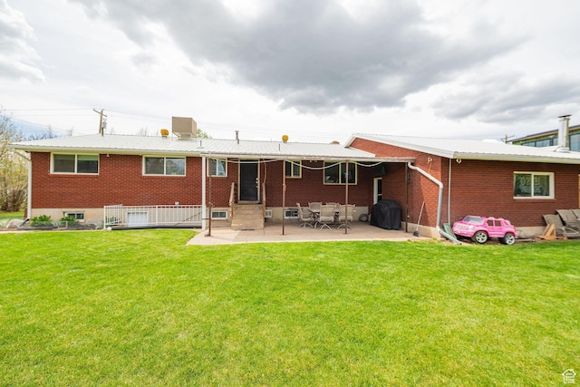 75 S 300 W, Morgan, UT 84050 - rear view of property with a patio, a lawn, brick siding, and entry steps