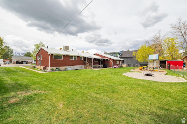 75 S 300 W, Morgan, UT 84050 - back of property featuring a lawn, brick siding, fence, and a playground